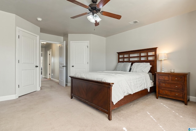 bedroom with visible vents, light carpet, baseboards, and ceiling fan