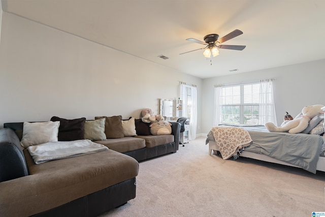 bedroom with ceiling fan, visible vents, and light carpet