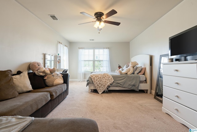 bedroom featuring ceiling fan, baseboards, visible vents, and light carpet