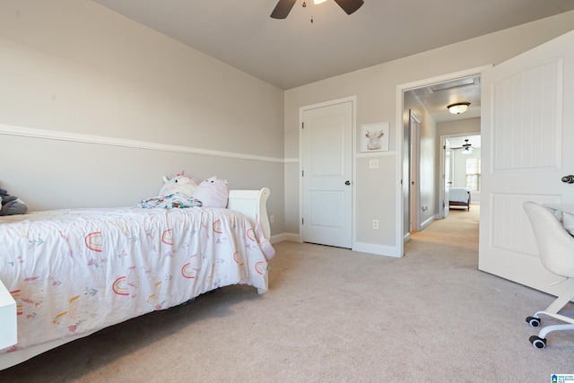 carpeted bedroom with baseboards and a ceiling fan