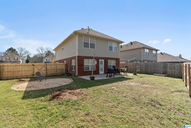 back of property with a patio area, brick siding, and a fenced backyard