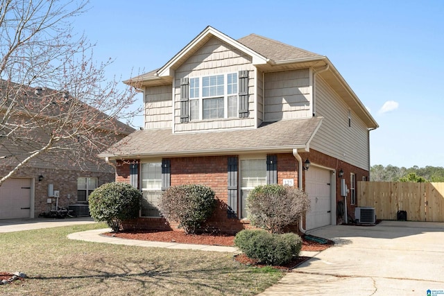 traditional home with brick siding, fence, concrete driveway, roof with shingles, and cooling unit