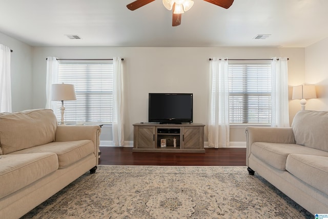 living room with visible vents, a healthy amount of sunlight, and wood finished floors