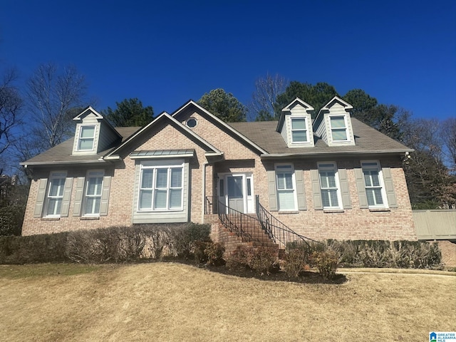 view of front of property with brick siding and a front yard