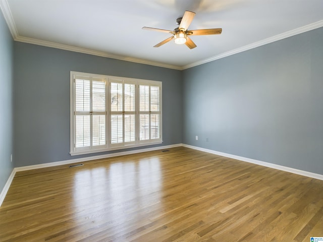 unfurnished room with crown molding and wood finished floors