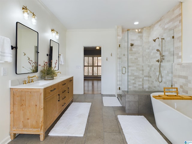 full bath with a stall shower, ornamental molding, a sink, and a soaking tub