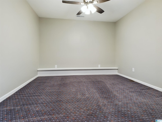 unfurnished room with carpet floors, visible vents, ceiling fan, and baseboards