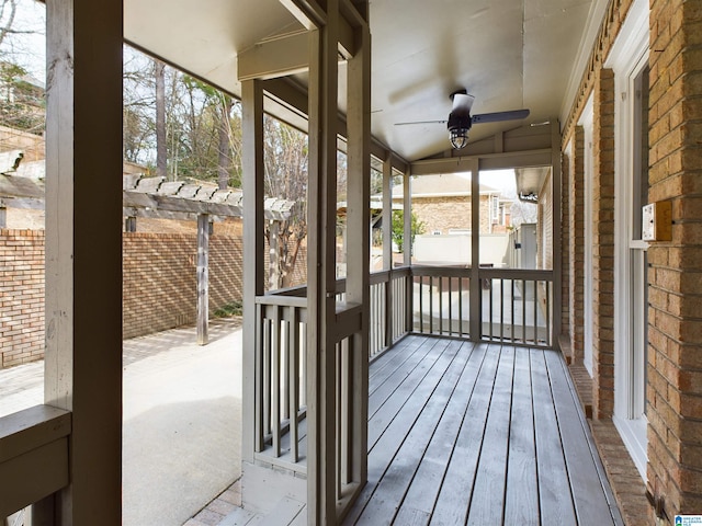 unfurnished sunroom featuring ceiling fan and vaulted ceiling