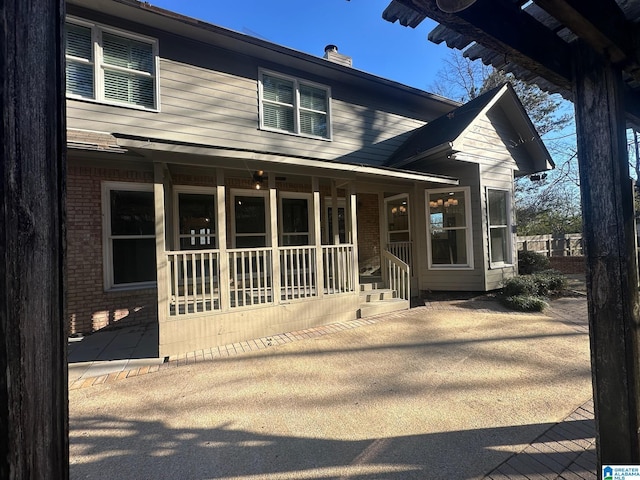 view of front of house with covered porch and brick siding