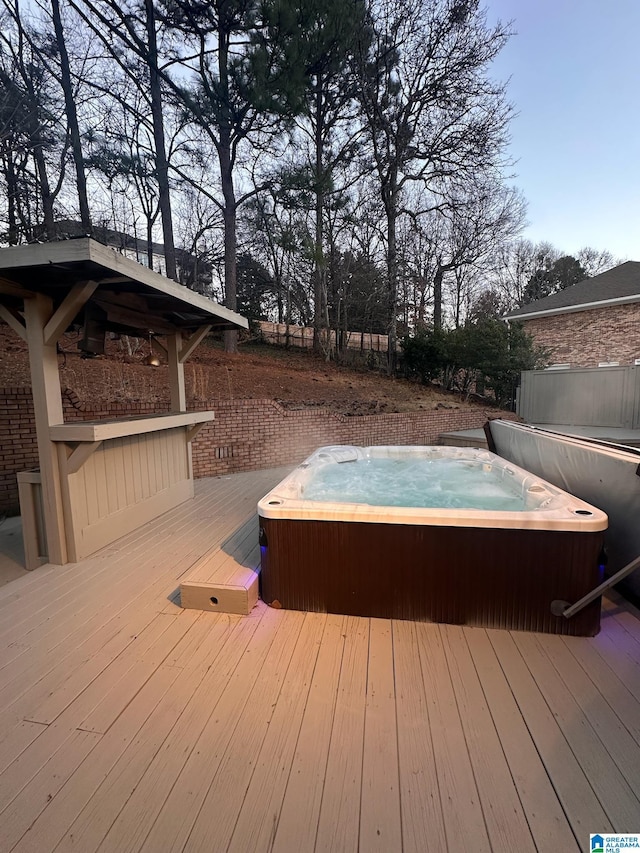 deck with a covered hot tub