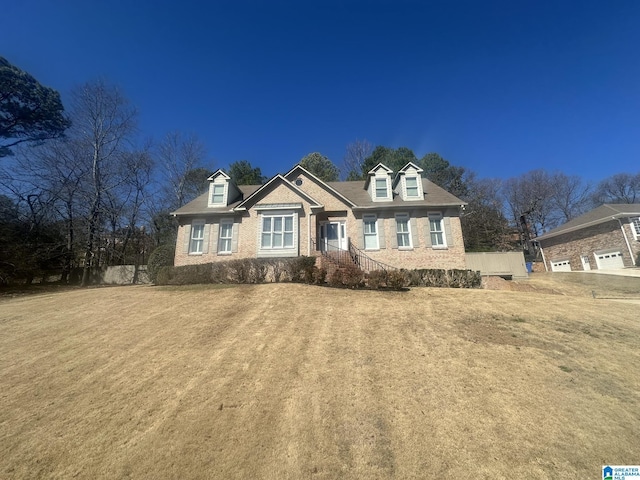 view of front facade featuring a front yard and brick siding