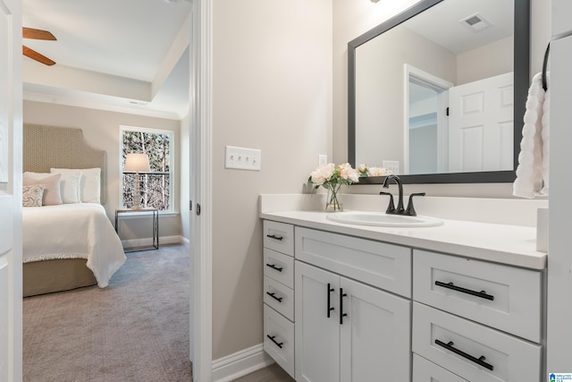 ensuite bathroom featuring visible vents, ensuite bathroom, ceiling fan, vanity, and baseboards