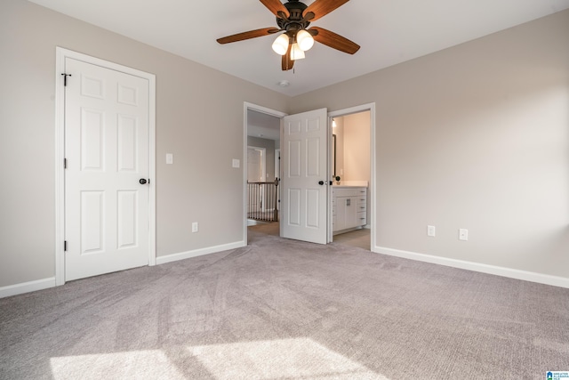 unfurnished bedroom featuring ceiling fan, carpet floors, connected bathroom, and baseboards