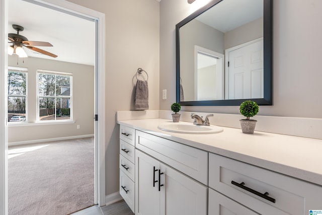 bathroom with ceiling fan, baseboards, and vanity