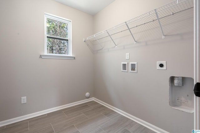 clothes washing area with hookup for a washing machine, laundry area, wood finish floors, baseboards, and electric dryer hookup