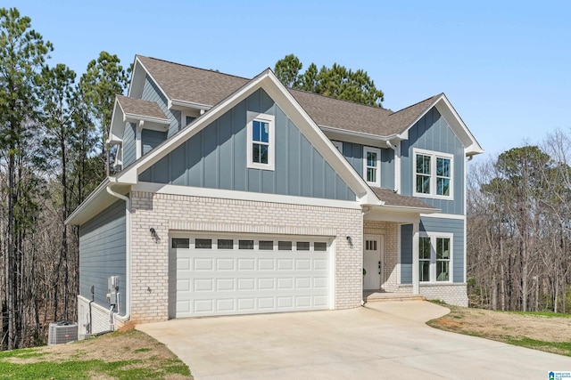 view of front of house featuring an attached garage, driveway, board and batten siding, and brick siding