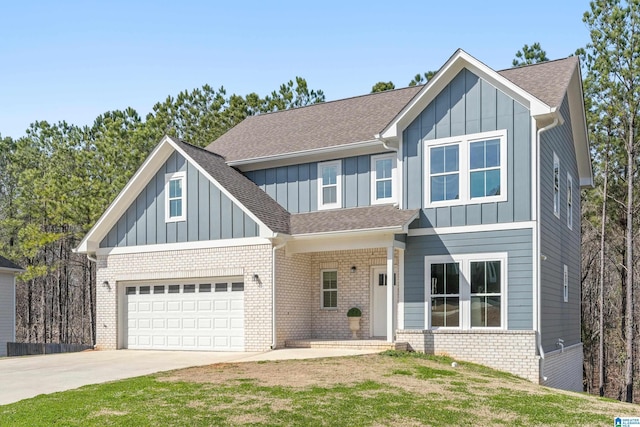 view of front of property with board and batten siding, brick siding, a shingled roof, and a garage