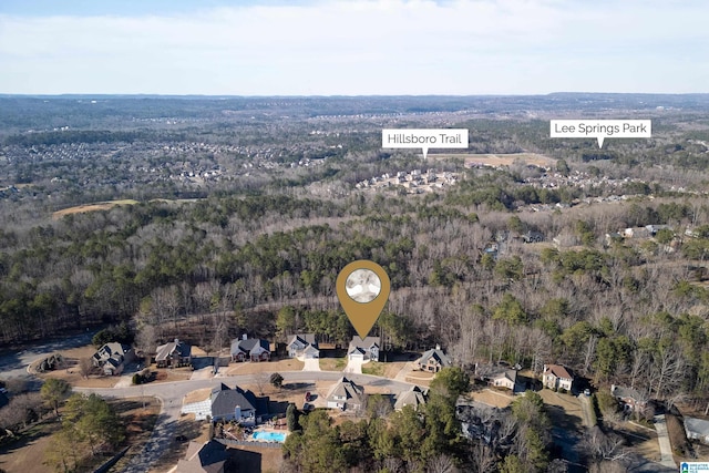 birds eye view of property featuring a view of trees