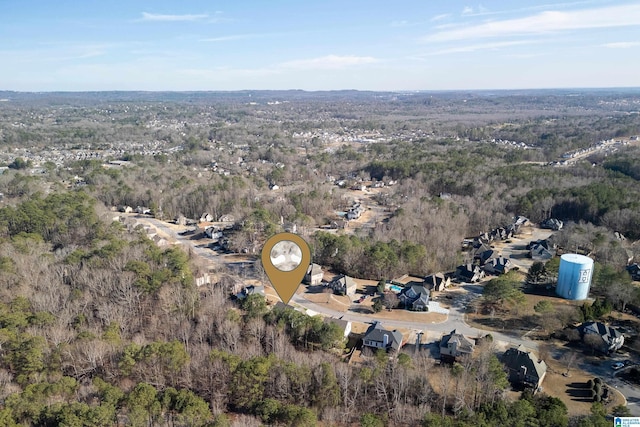 bird's eye view with a wooded view