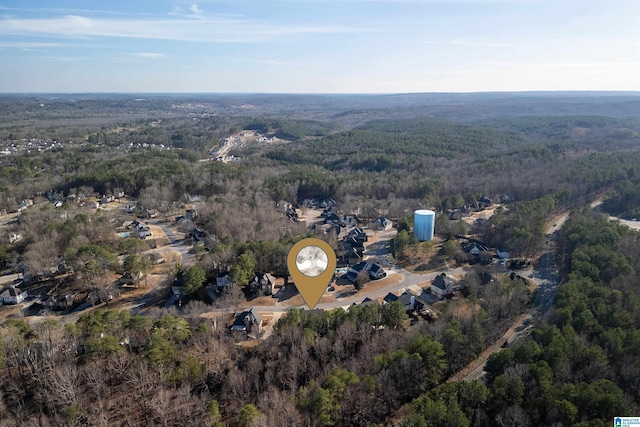 birds eye view of property featuring a wooded view