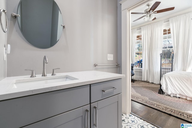 bathroom featuring ensuite bath, wood finished floors, vanity, and a ceiling fan