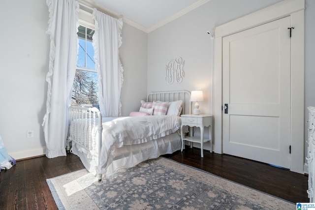 bedroom featuring dark wood-style floors, baseboards, and ornamental molding