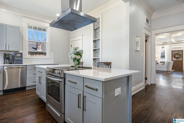 kitchen with island range hood, coffered ceiling, a center island, stainless steel appliances, and gray cabinetry