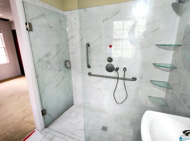 full bath with a sink, a shower stall, and tile walls