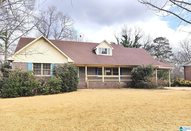 view of front of home featuring a front yard and brick siding