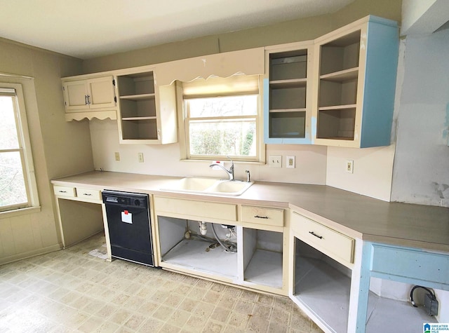 kitchen featuring black dishwasher, glass insert cabinets, light countertops, open shelves, and a sink