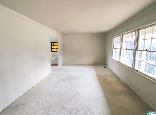 unfurnished room with light carpet, visible vents, and crown molding