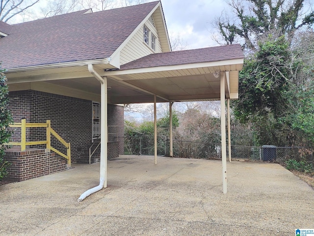 view of car parking with a carport and fence