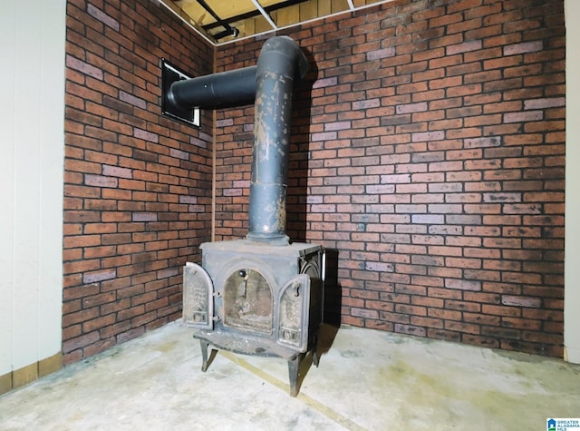 interior details with a wood stove and unfinished concrete flooring