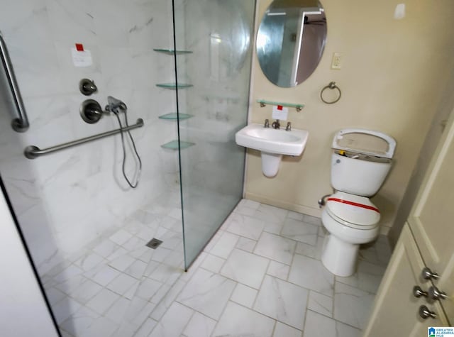 full bath with toilet, a marble finish shower, baseboards, and a sink