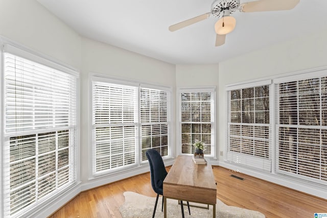 sunroom with a ceiling fan, visible vents, and plenty of natural light