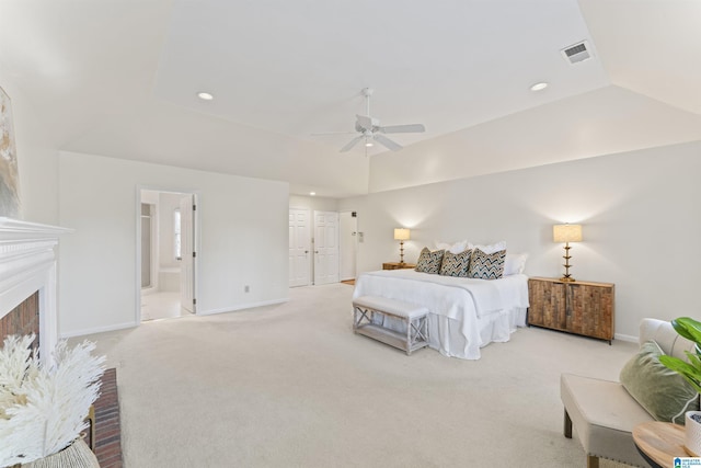 bedroom featuring baseboards, visible vents, a fireplace with raised hearth, light colored carpet, and lofted ceiling