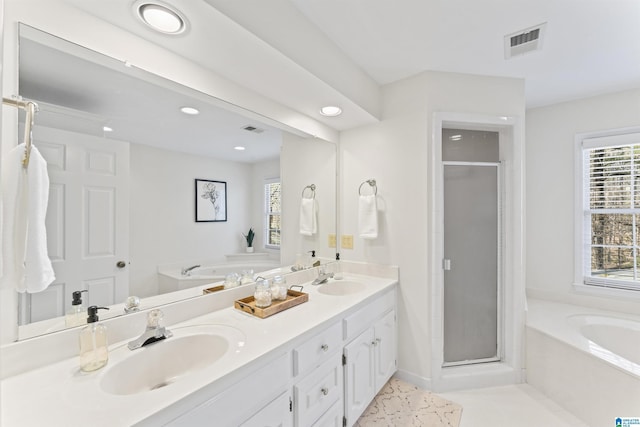 full bath featuring a bath, a shower stall, visible vents, and a sink