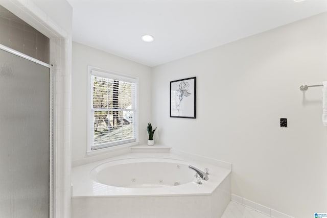 full bathroom with a stall shower, baseboards, and a whirlpool tub