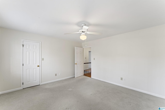 interior space featuring carpet flooring, ceiling fan, and baseboards