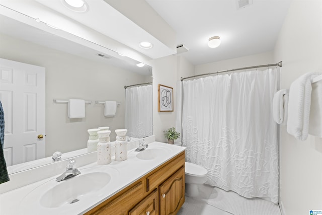 full bathroom featuring visible vents, a sink, toilet, and double vanity