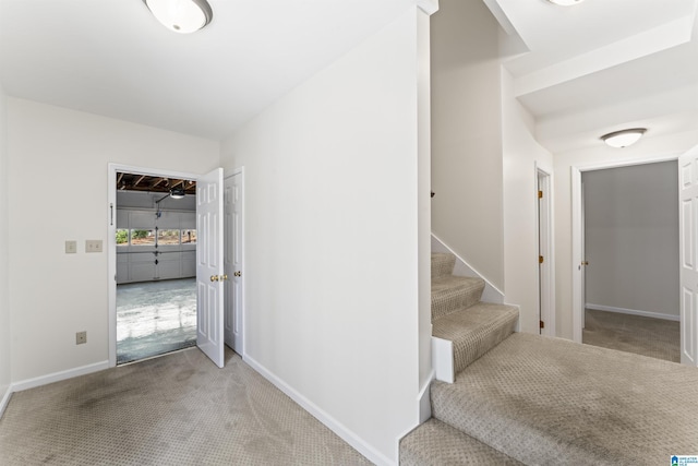 interior space featuring carpet flooring and baseboards