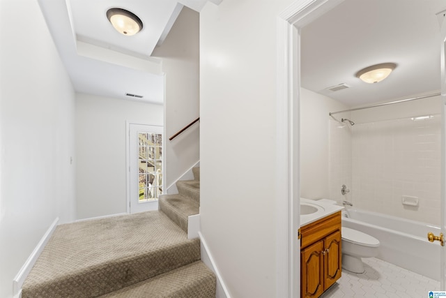 bathroom featuring visible vents, bathing tub / shower combination, vanity, and toilet