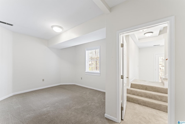 below grade area featuring stairway, carpet, visible vents, and baseboards