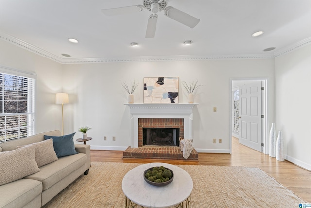 living area featuring a brick fireplace, wood finished floors, and baseboards