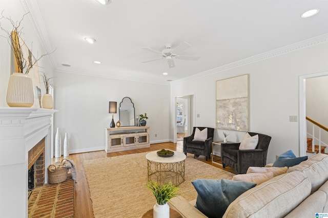 living room featuring baseboards, stairway, ornamental molding, wood finished floors, and a brick fireplace