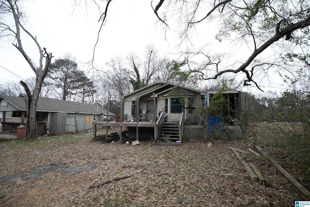 rear view of house featuring a deck