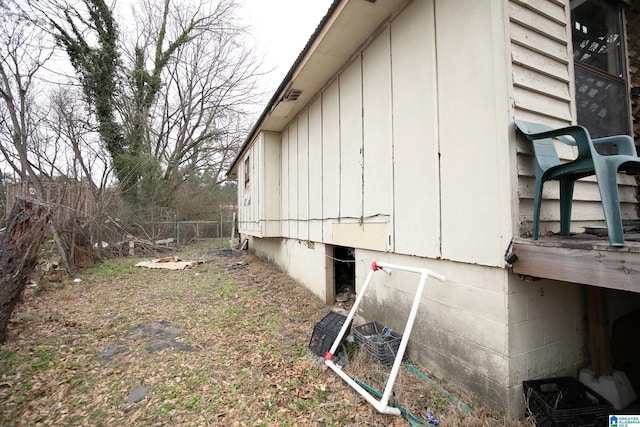 view of side of home featuring fence