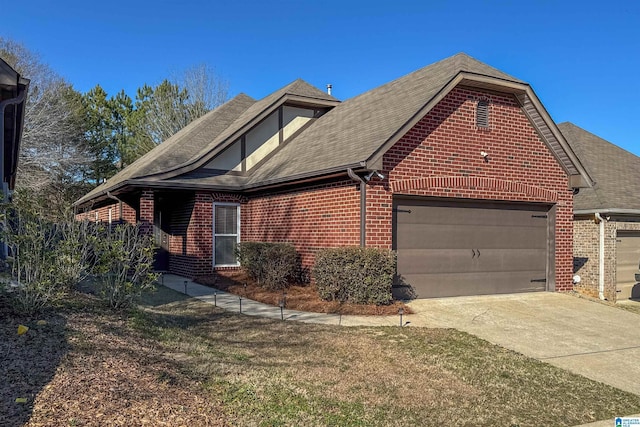 view of home's exterior featuring a garage, concrete driveway, and brick siding