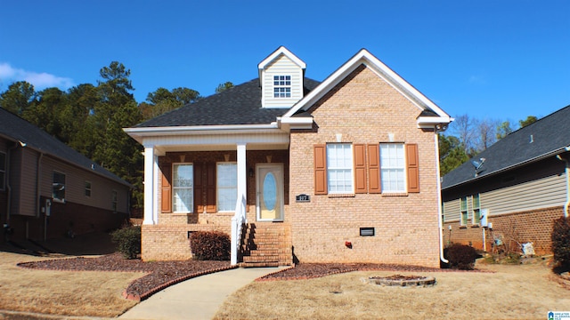 view of front of house with crawl space and brick siding