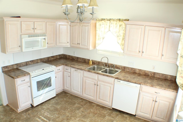 kitchen featuring white appliances, dark countertops, and a sink